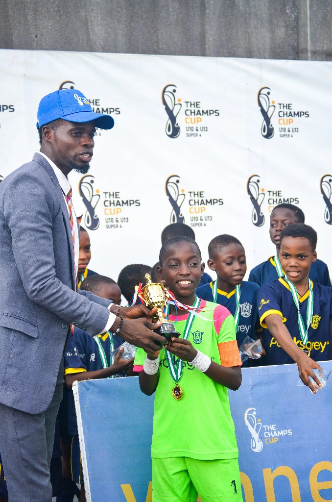 Angel Salt handing out a trophy at the Champs Cup in Lagos, Nigeria - hosted by the Angel Salt Foundation